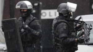Armed French intervention police stand ready at the scene of a shooting in the street of Montrouge near Paris