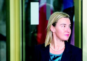 Steinmeier welcomes Mogherini before the beginning of a conference in Berlin