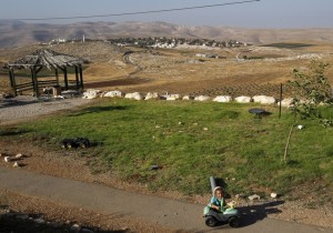A boy plays on the Maale Shlomo outpost beside the West Bank Jewish settlement of Kochav Hashahar