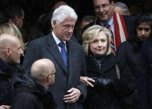 Former U.S. president Bill Clinton and his wife, former U.S. Secretary of State Hillary Clinton, depart after the funeral service for former New York Governor Cuomo in New York