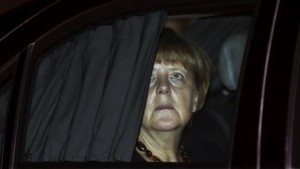 German Chancellor Merkel sits in her car after her arrival at the airport in New Delhi