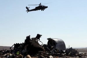 An Egyptian military helicopter flies over debris from a Russian airliner which crashed at the Hassana area in Arish city, north Egypt
