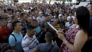 Costa Rica's Immigration Administration Director Kathya Rodriguez calls the roll of Cubans leaving for their journey to the Guatemala-Mexico border in La Cruz