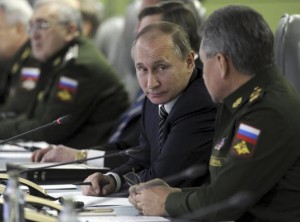 File photo of Russian President Putin looking at Defence Minister Shoigu as they attend meeting dealing with commissioning of military products in Moscow