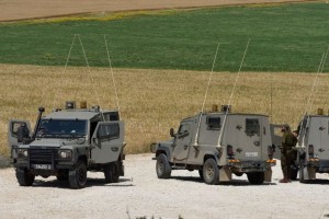 Israeli soldiers patrol near the Israel Gazan border